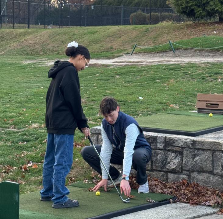 Mentor giving a putting lesson