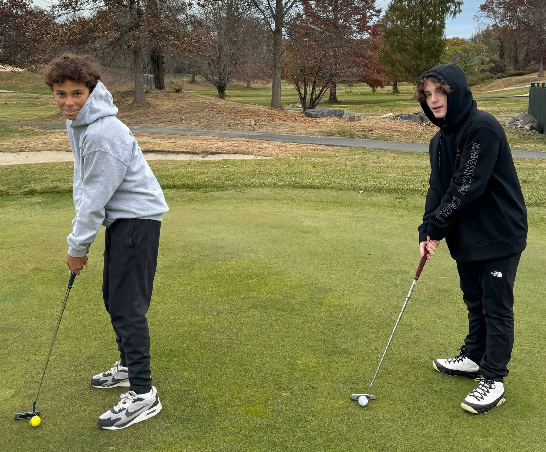 Two students putting
