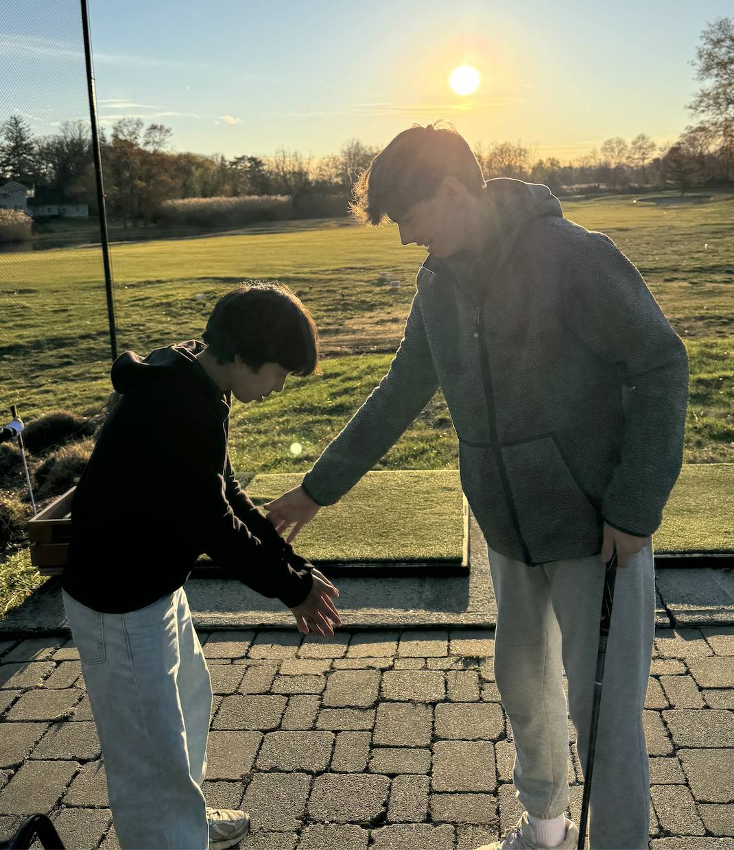 Mentor working with a student at sunset